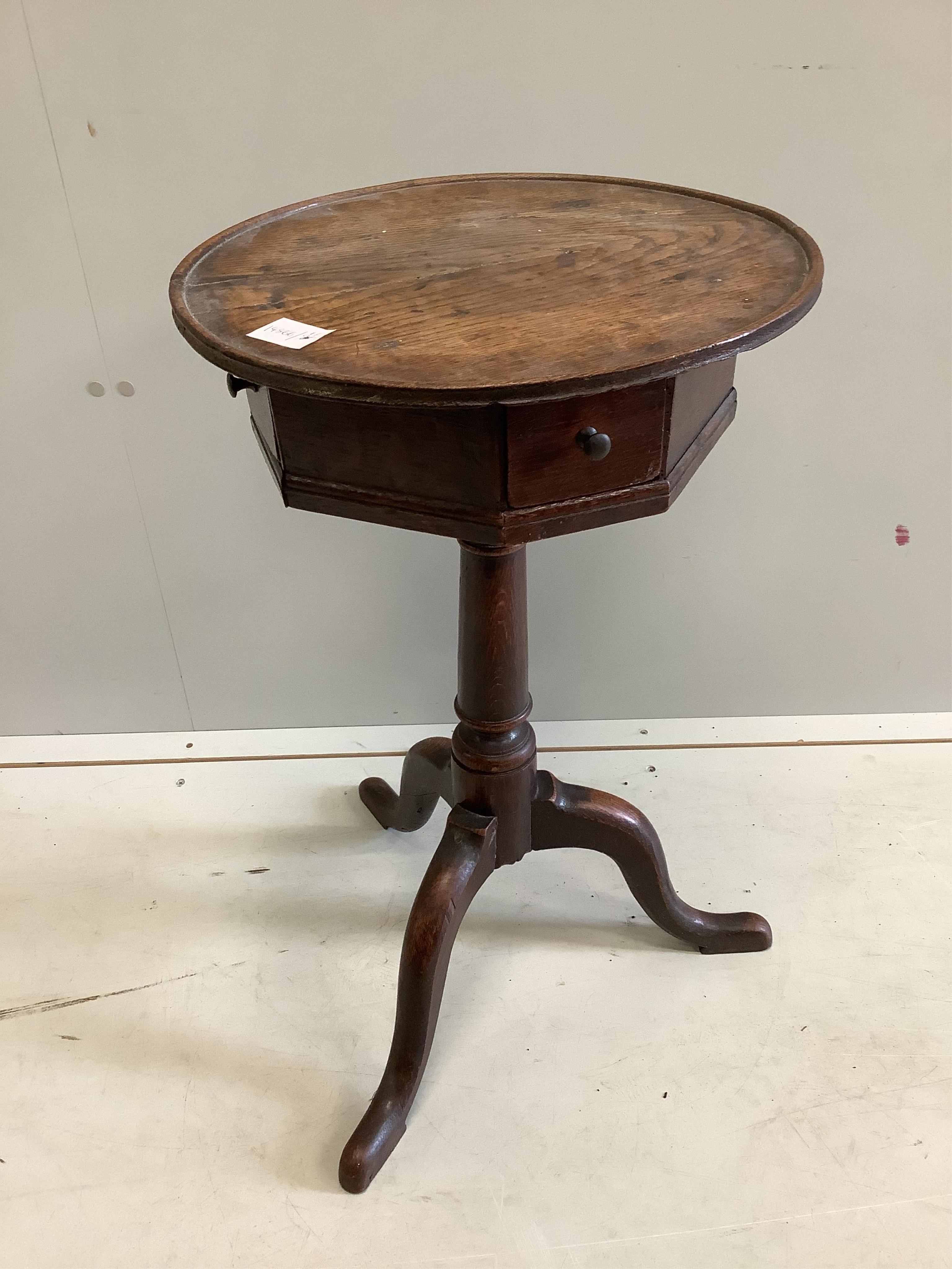 A George III provincial oak circular tripod wine table, fitted drawers, diameter 39cm, height 69cm. Condition - fair